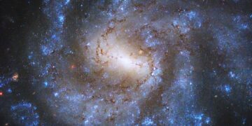 NASA confirms it—Hubble captures a spiral galaxy teeming with newborn stars, and the sight is dazzling