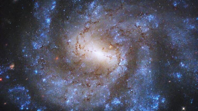NASA confirms it—Hubble captures a spiral galaxy teeming with newborn stars, and the sight is dazzling