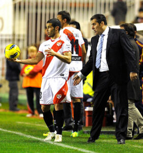 Rayo Vallecano's coach Jose Ramon Sandoval (L) gives instructions to his defender Jose Manuel Casado (L) during the Spanish league football match Rayo Vallecano vs Valencia at the Teresa Rivero stadium in Vallecas, on November 26, 2011. AFP PHOTO/ DOMINIQUE FAGET (Photo credit should read DOMINIQUE FAGET/AFP via Getty Images)