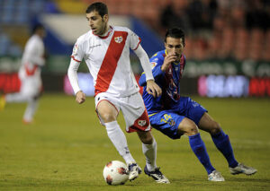 Rayo Vallecano's midfielder Roberto Trashorras (L) fights for the ball with Levante's midfielder Xavi Torres (R) during the Spanish league football match Levante UD vs Rayo Vallecano on February 19,2012 in Valencia. AFP PHOTO/ JOSE JORDAN (Photo credit should read JOSE JORDAN/AFP via Getty Images)