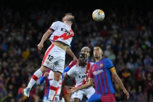 Rayo Vallecano's Spanish midfielder Unai Lopez (L) heads the ball during the Spanish league football match between FC Barcelona and Rayo Vallecano de Madrid at the Camp Nou stadium in Barcelona on April 24, 2022. (Photo by LLUIS GENE / AFP) (Photo by LLUIS GENE/AFP via Getty Images)