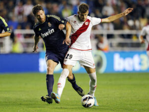 MADRID, SPAIN - SEPTEMBER 24: Xabi Alonso of Real Madrid competes for the ball with Leo Baptistao of Rayo Vallecano during the La Liga match between Rayo Vallecano and Real Madrid at Estadio Teresa Rivero on September 24, 2012 in Madrid, Spain. (Photo by Helios de la Rubia/Real Madrid via Getty Images)
